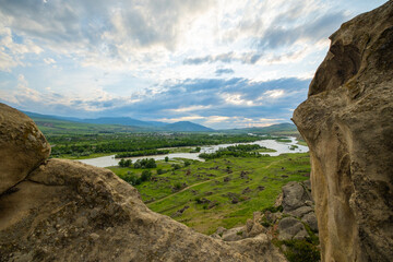 Scenic sunset views looking across the Kura River from the top of the ancient rock town of Uplistsikhe near the city of Gori, Georgia © hyserb