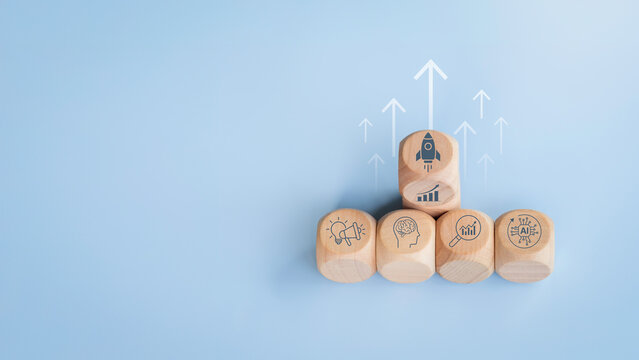 Growth hacking strategy with creative marketing, behavioral psychology, data analytics, and AI technology automation, represented by wooden cubes with icons symbolizing innovation and business growth