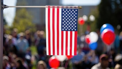 American flag waves at an outdoor gathering with balloons