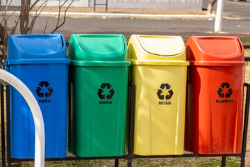 Colorful recycling bins for paper, glass, metal, and plastic in Brazil. Illustrates waste sorting,...