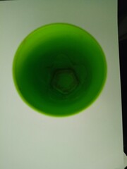 Close-up view from above of a green atom mug on a white background