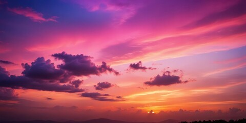 Obraz premium Soft pink hue blends with deep purple tones in the evening sky as sunset fades slowly