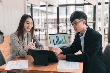 Engaged professionals in a collaborative data analysis meeting with digital presentations