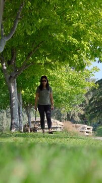 Attractive Chinese woman walking two small dogs