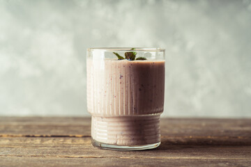 Blueberry and bananas smoothie on the rustic background. Selective focus.