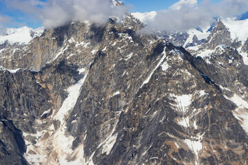 A close-up view of a rugged, snow-streaked mountain face in Denali National Park. The detailed...