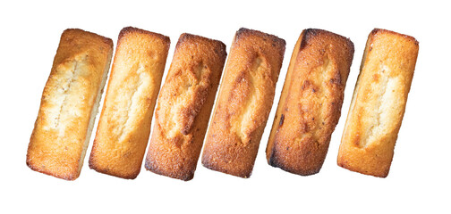 neat row of golden almond financiers on black backdrop