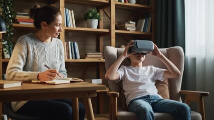 Young woman and boy engaging with virtual reality headset in cozy home setting - Powered by Adobe