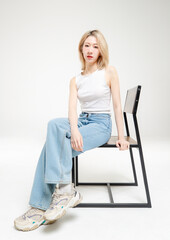 Asian fashion portrait young beautiful cheerful cute woman, blonde short hair wearing white tank...