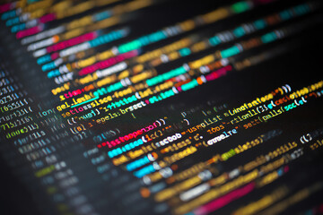 Close-up of colorful programming code displayed on a dark computer screen, highlighting various functions, variables, and syntax in a software development environment