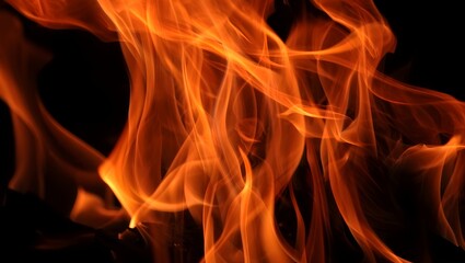 Fototapeta premium Close up of vibrant orange fire flames against a black background