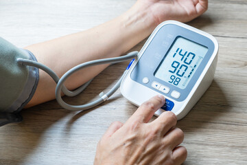 Man check blood pressure monitor and heart rate monitor with digital pressure gauge. Health care...