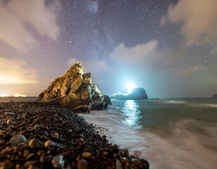 Dramatic night seascape with starry sky and dreamy wave action perfect for travel blogs or...