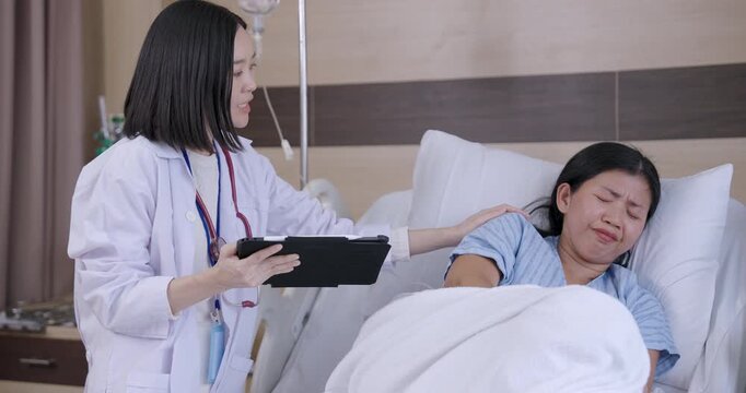 Slowmotion moment as female patient covers face after receiving emotional news from female doctor during hospital consultation showing stress and vulnerability in real healthcare situation