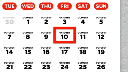 Close-up of the date October 10th marked with a red cursor on the wall calendar 2025