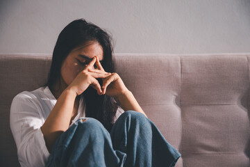 Despair sorrow person in empty dark room, Depressed young woman covering face with hands. Young...