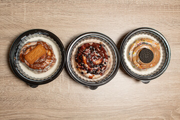 A row of three assorted cinnamon rolls with different toppings
