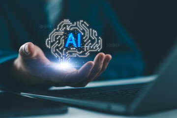 Machine learning and human-computer interaction in smart business solutions. Artificial intelligence (AI) technology concept with digital brain hologram above hand. Futuristic innovation,