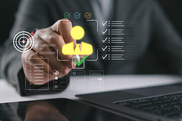 Man holding stylus pointing at virtual candidate profile with checklist and approval icons on laptop screen, concept of human resources, recruitment process, employee evaluation and selection system.