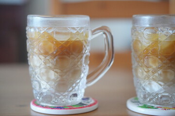 Refreshing Iced Café Latte Style Drink in Transparent Glass Mugs with Ice Cubes and Cream, Summer Beverage for Relaxation and Refreshment at Home