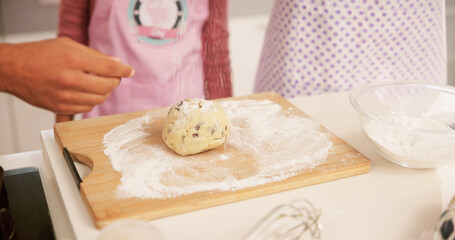 Baking, family and hands of people in kitchen together for child development, learning or recipe. Dough, flour or ingredients with parents teaching daughter how to bake in apartment for cooking