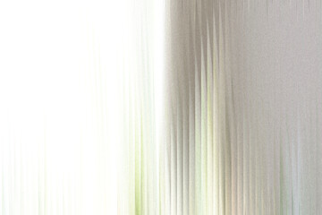 Fototapeta premium A soft, blurred abstract background with vertical lines and a gradient from bright white to muted gray, evoking a sense of gentle movement and light