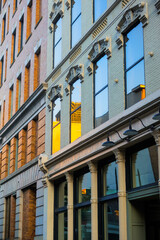 Traditional typical western architecture of a building with reflection in the glass windows.