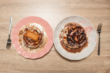 A flat lay of two assorted cinnamon rolls for sharing