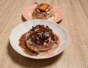 Two assorted gourmet cinnamon rolls with a shallow depth of field