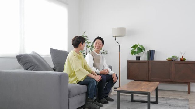 A middle-aged couple relaxing in the living room