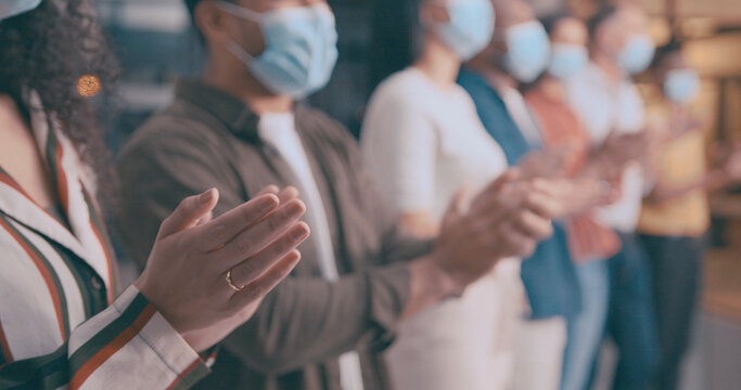 Applause, face mask and hands of business people in office for achievement, motivation or success. Celebration, crowd and support with employee team in PPE, clapping for bonus, goals or target - Powered by Adobe