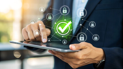 Businessman uses tablet to manage secure digital network, connecting user profiles and data with verified checkmark icon