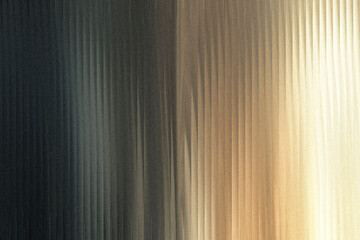 Fototapeta premium A textured background with vertical lines transitioning from dark gray to golden yellow, creating a sense of depth and light