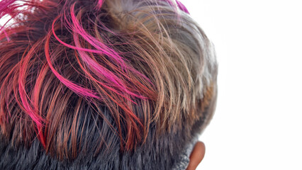 A close-up view of styled hair showcasing vivid pink highlights blended with natural tones. The...