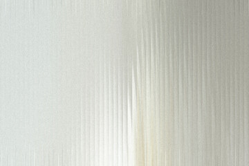 Fototapeta premium A textured metallic surface with vertical lines and a subtle glitter effect, creating a shimmering and reflective background