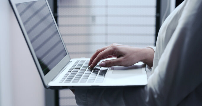 Business, hands and woman with laptop, programmer and software engineering with cyber security. Closeup, coder or person in workplace, pc or writing code with web development, password or programming