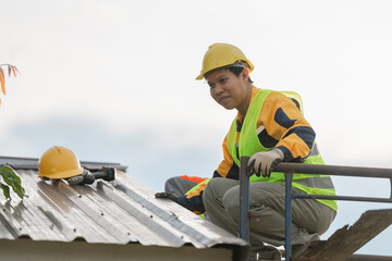 Construction Worker on Roof Engaged in Renovation Task During Clear Day, Wearing Safety Gear and...