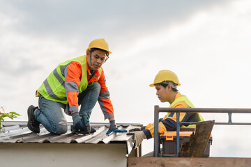 Construction Workers Installing Metal Roofing Panels on Building Under Clear Sky During Daylight...
