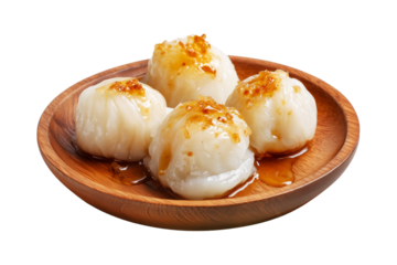 Coconut rice balls or dumplings topped with syrup and shredded coconut on wooden plate, isolated on white transparent background, concept of Polynesian Snacks Faikakai dessert cuisine