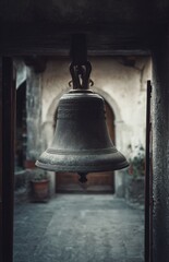 Obraz premium Large metal bell hanging in a stone building