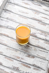 Mango smoothie on bright background. Soft focus. Copy space.