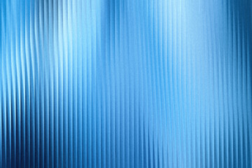 Obraz premium A textured blue background with vertical ribbed patterns and a soft, luminous gradient