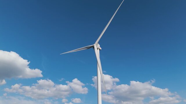 Aerial drone close-up of wind turbine blades spinning under bright blue sky. Showcasing green energy, sustainability and help preventing. climate change.