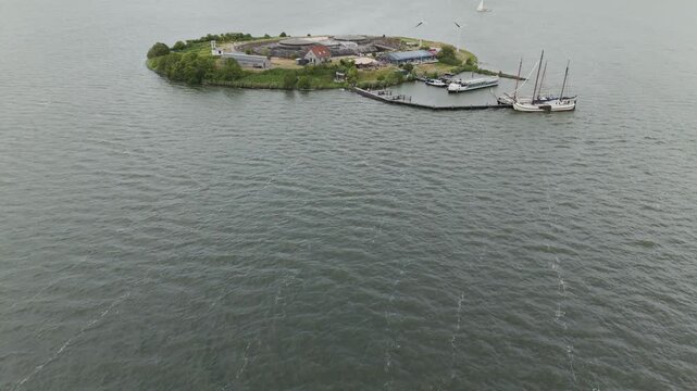 Stunning aerial drone footage of Pampus island in the IJmeer near Amsterdam, featuring the historic fort, harbor, and sailing boats.