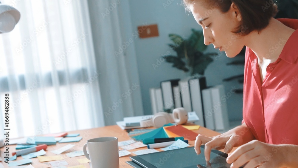 Aufkleber top view of designer writing idea on colorful sticky notes while sitting at meeting table with table