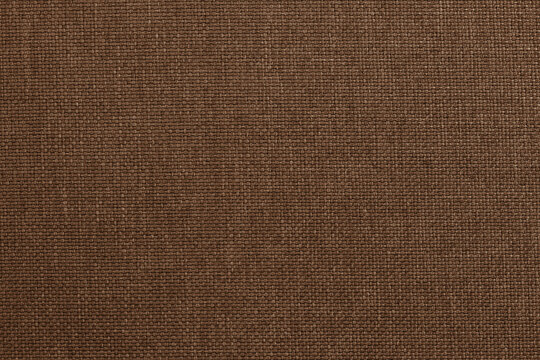 Dark brown fabric texture for background and design art work with seamless pattern of natural textile.