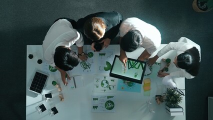 Top view of manager hold tablet display clean energy investment at meeting. Aerial view of skilled...