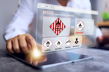 flammable solid and warning labels concept with safety staff checking hazard data for flammable...