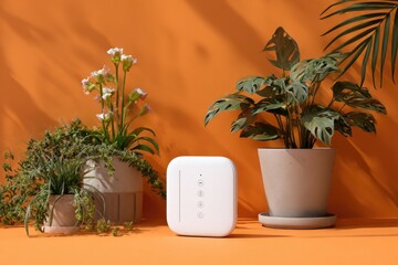 Modern smart home device amidst potted plants