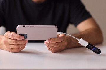 man using otg usb with her mobile phone to copy photos